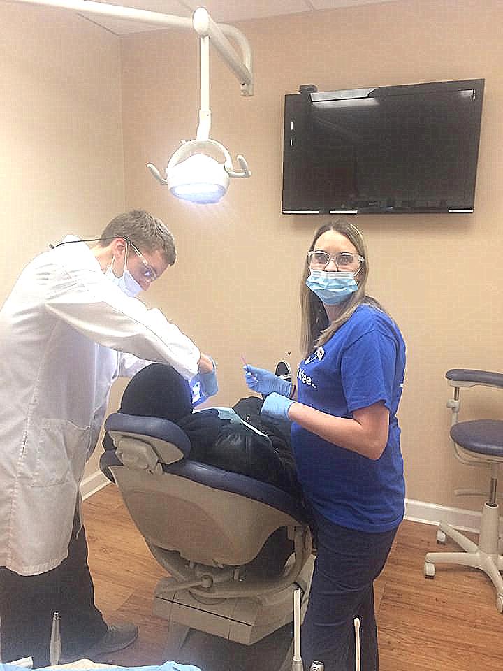 Dr. Justin Neibauer performing root canal procedure at his dental clinic in
