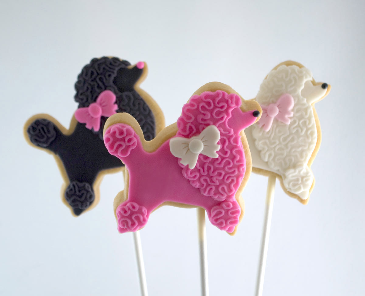 Decorated shortbread cookies on stick.